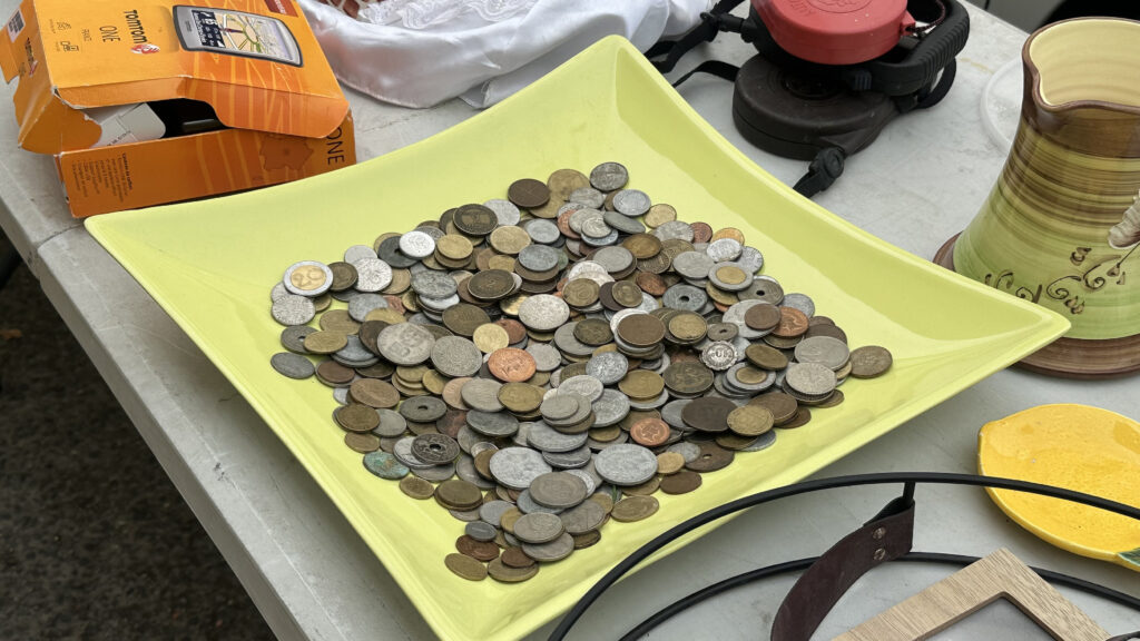 Dish containing coins